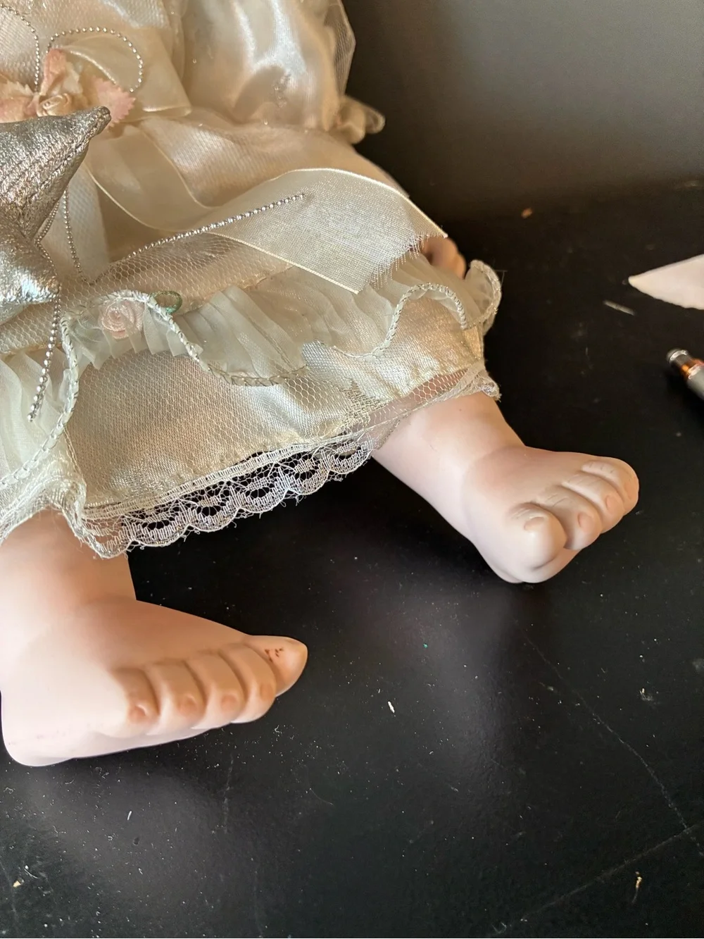 Vintage porcelain doll holding wand and wearing halo